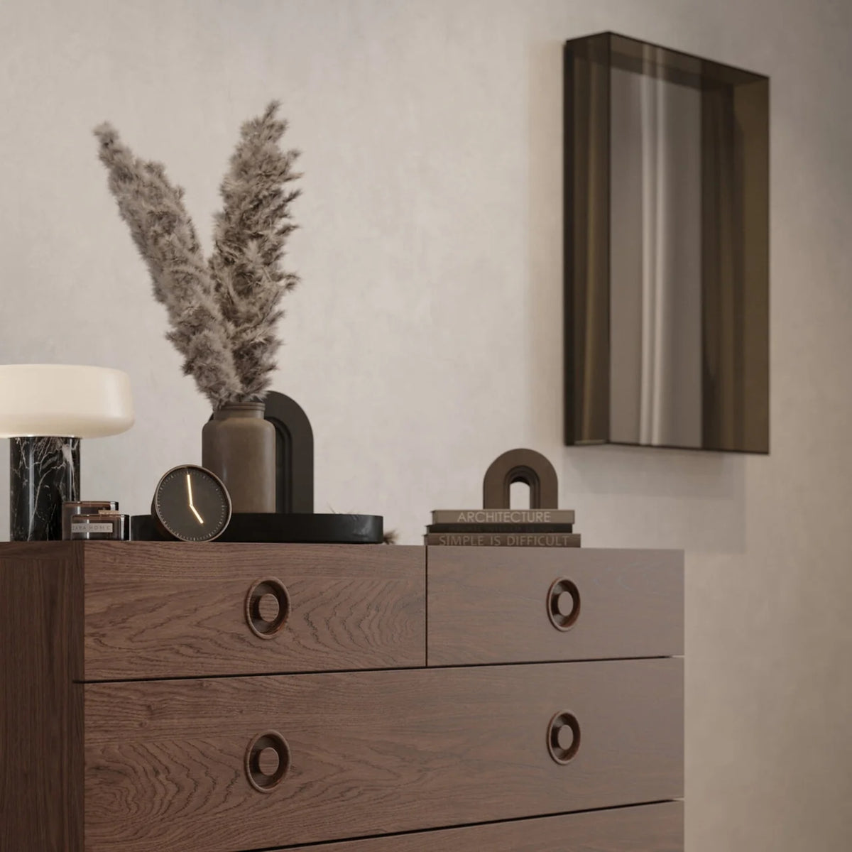 Case Lucent mirror in Smoke Glass above a dark wood chest of drawers