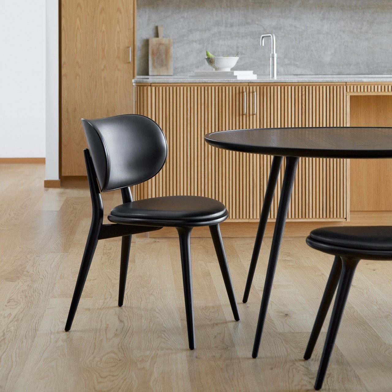 Mater Accent Dining Table in solid wood styled in a dining room