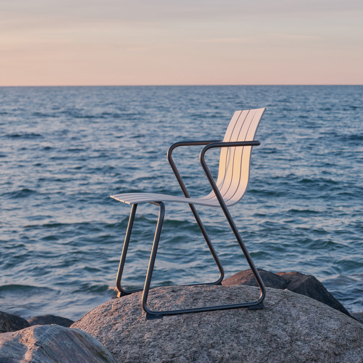 Mater Ocean Chair styled in an outdoor setting, slats of recycled plastic waste