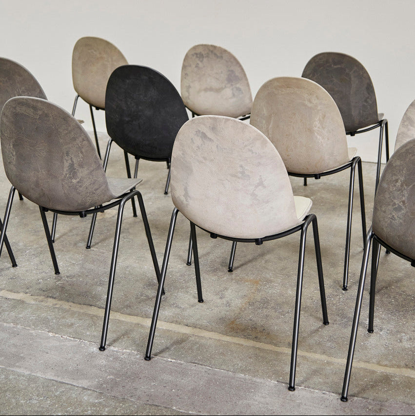 Mater Eternity Side Chair in Coffee Waste Black styled in an interior setting, Matek shell on a recycled steel frame