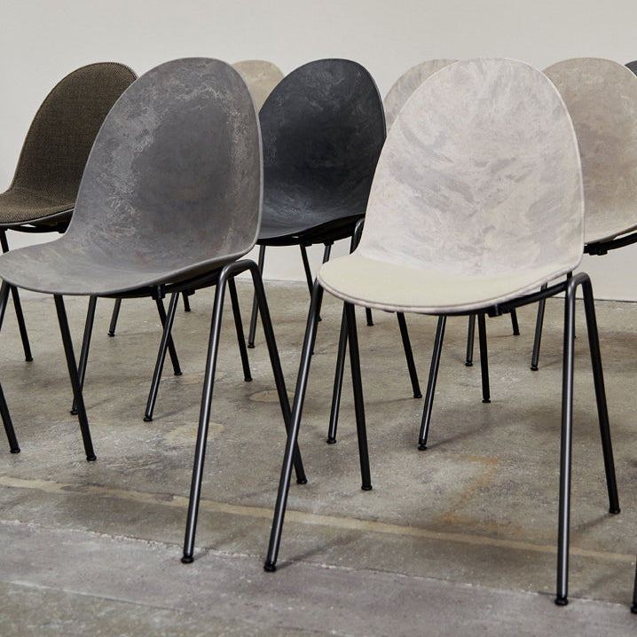 Mater Eternity Side Chair in Coffee Waste Black styled in an interior setting, Matek shell on a recycled steel frame