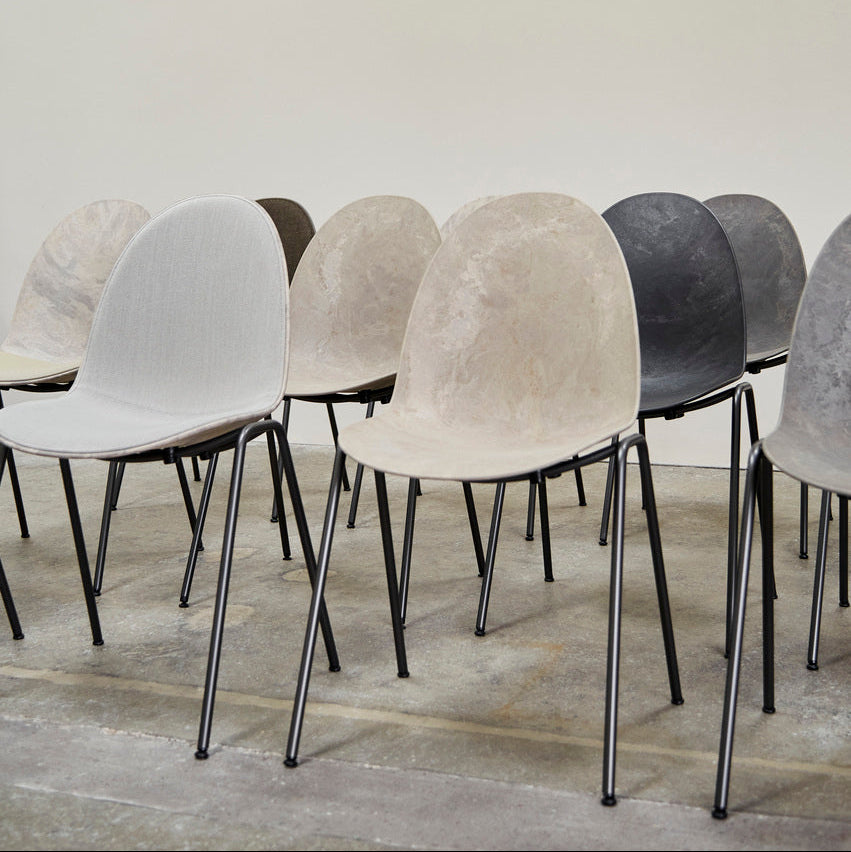 Mater Eternity Side Chair in Coffee Waste Black styled in an interior setting, Matek shell on a recycled steel frame