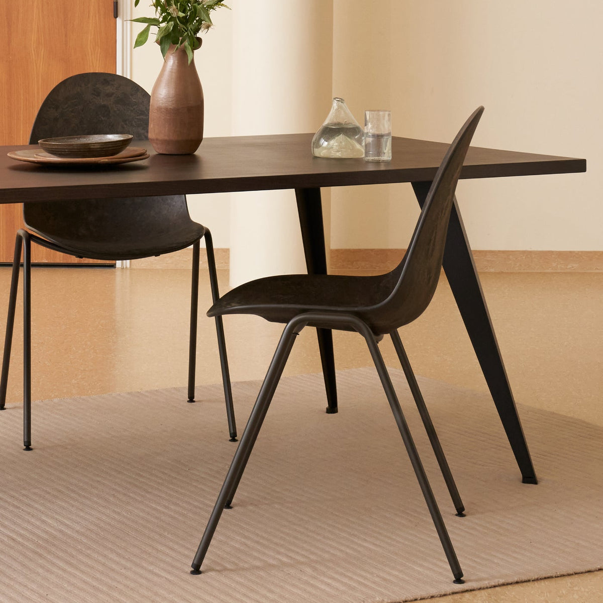 Mater Eternity Side Chair in Coffee Waste Black styled in an interior setting, Matek shell on a recycled steel frame