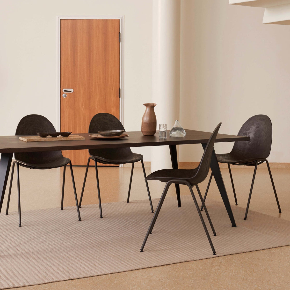 Mater Eternity Side Chair in Coffee Waste Black styled in an interior setting, Matek shell on a recycled steel frame