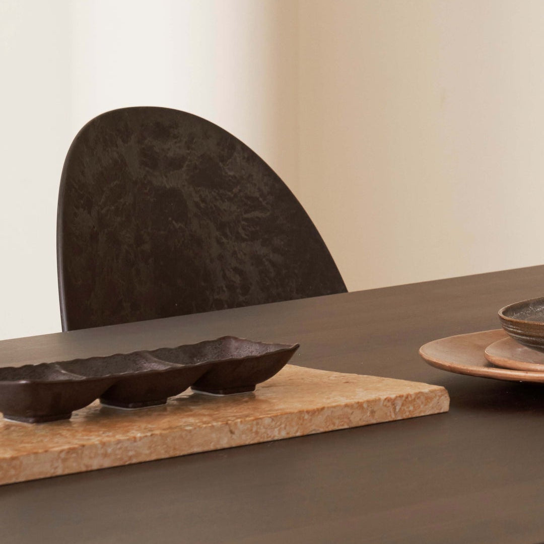 Mater Eternity Side Chair in Coffee Waste Black styled in an interior setting, Matek shell on a recycled steel frame