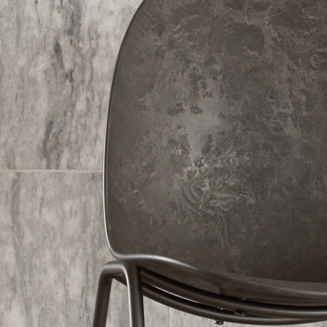 Mater Eternity Side Chair in Coffee Waste Black styled in an interior setting, Matek shell on a recycled steel frame