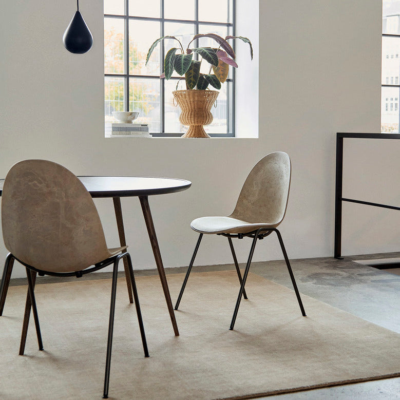 Mater Eternity Side Chair in Coffee Waste Dark styled in an interior setting, Matek shell on a recycled steel frame