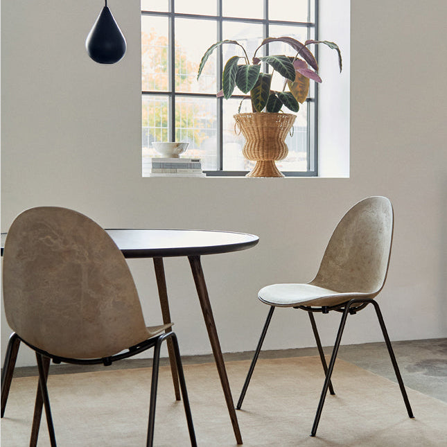 Mater Eternity Side Chair in Coffee Waste Dark styled in an interior setting, Matek shell on a recycled steel frame