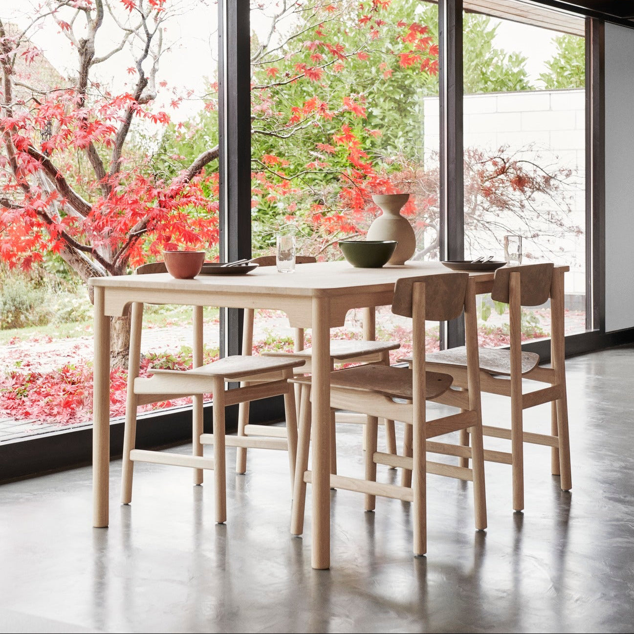 Mater Conscious Chair in solid wood, designed by Jorgen Moller, styled in an interior setting
