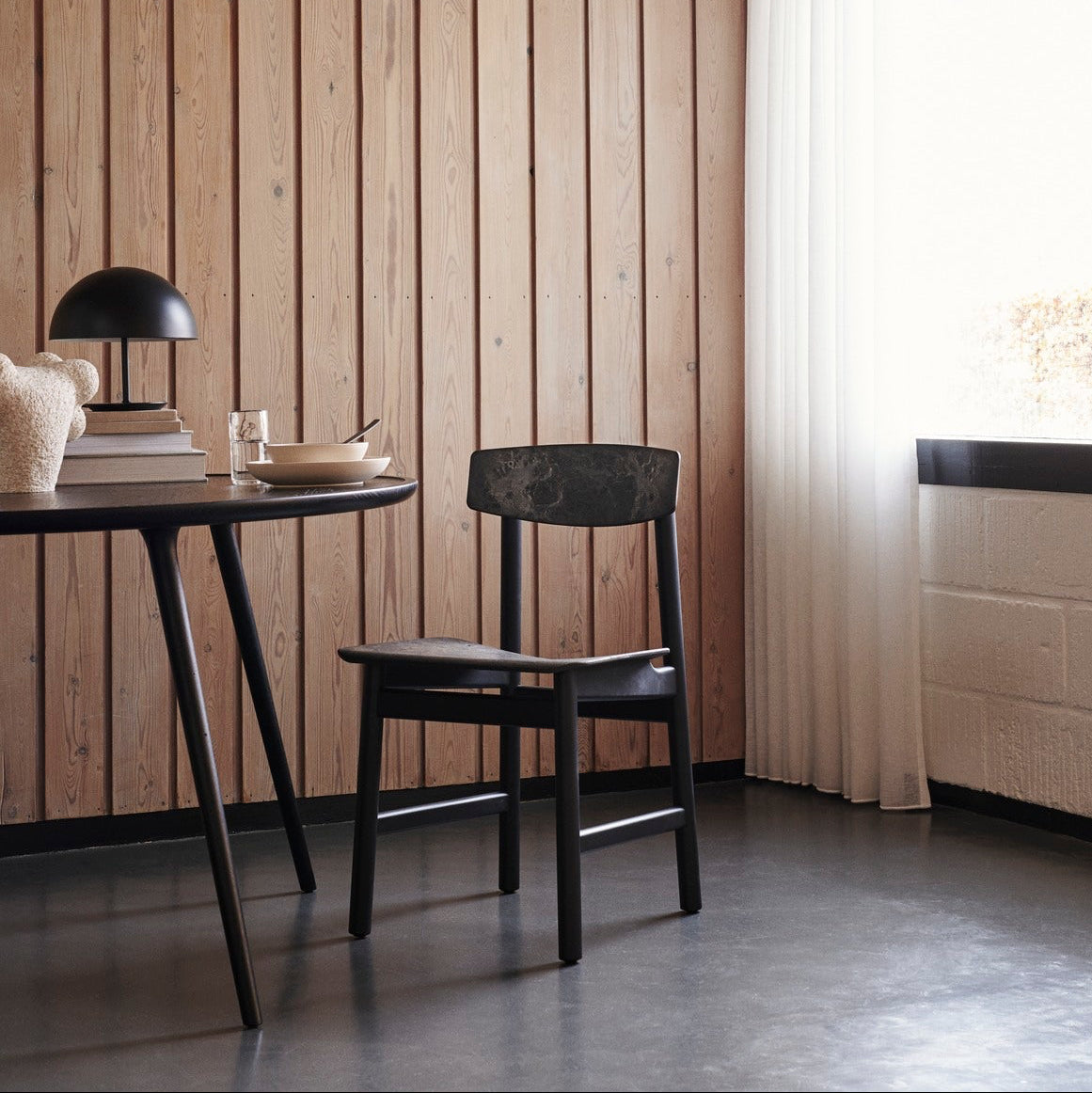 Mater Conscious Chair in solid wood, designed by Jorgen Moller, styled in an interior setting