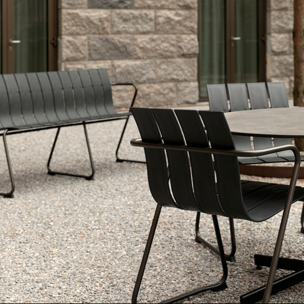 Mater Ocean Chair styled in an outdoor setting, slats of recycled plastic waste