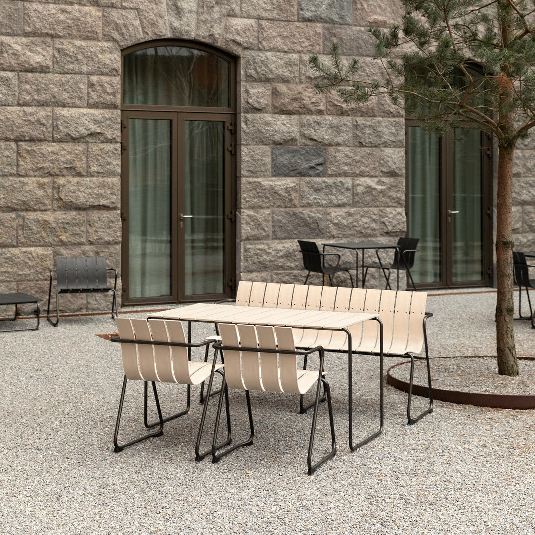 Mater Ocean 4 Person Dining Table styled in an outdoor setting, slats of recycled plastic waste