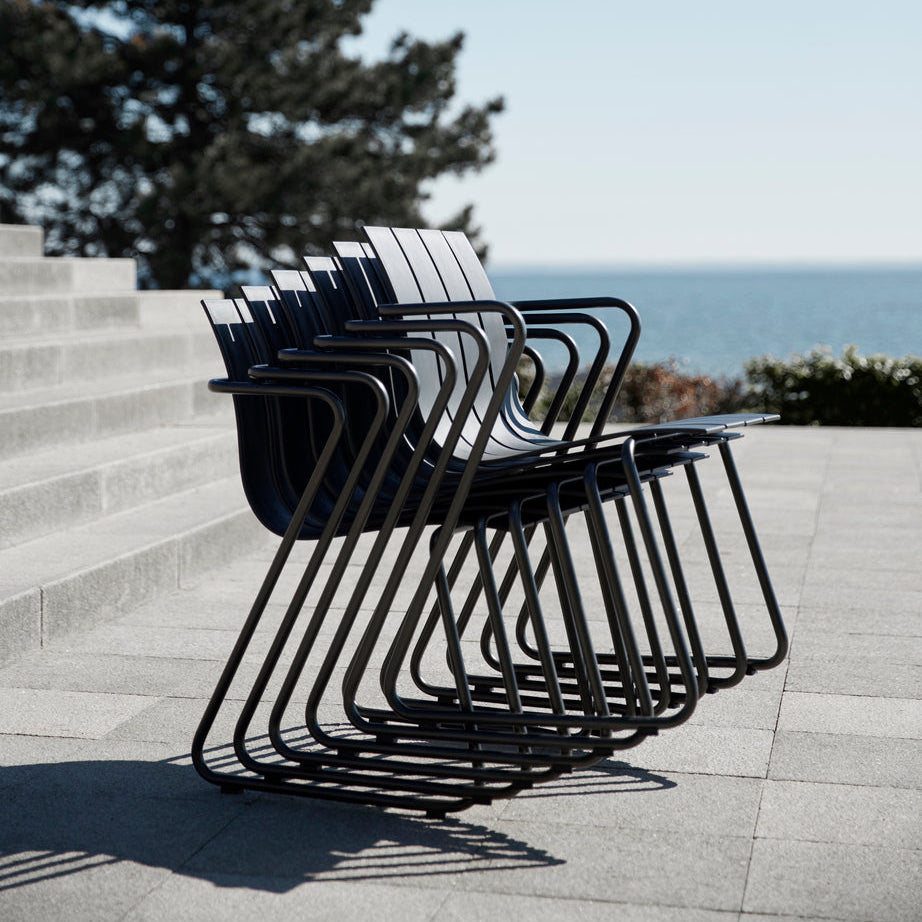 Mater Ocean Chairs stacked outdoors, slats of recycled ocean waste plastic