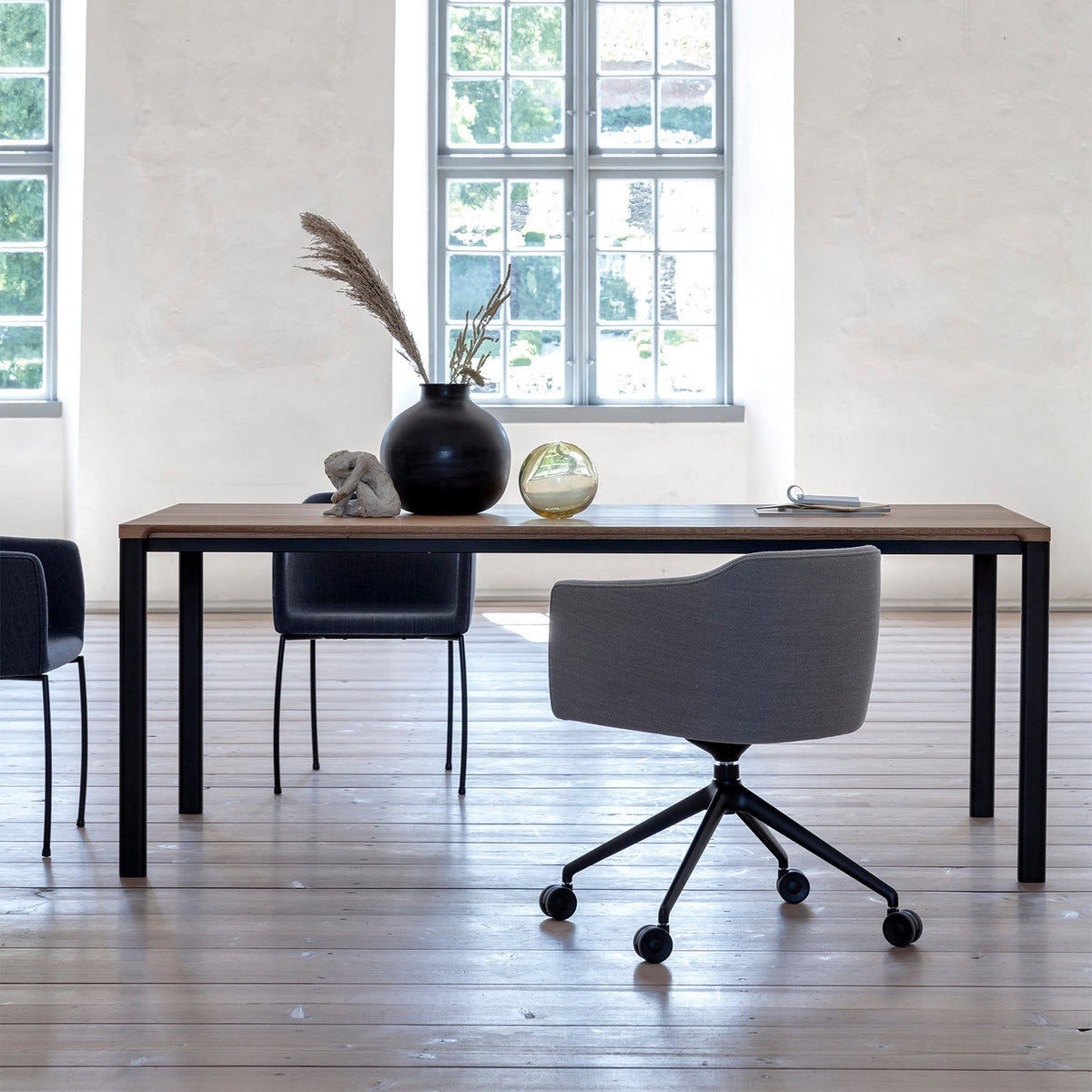 Bent Hansen Meet Dining Table in solid oiled oak, styled in an interior setting, oak and steel