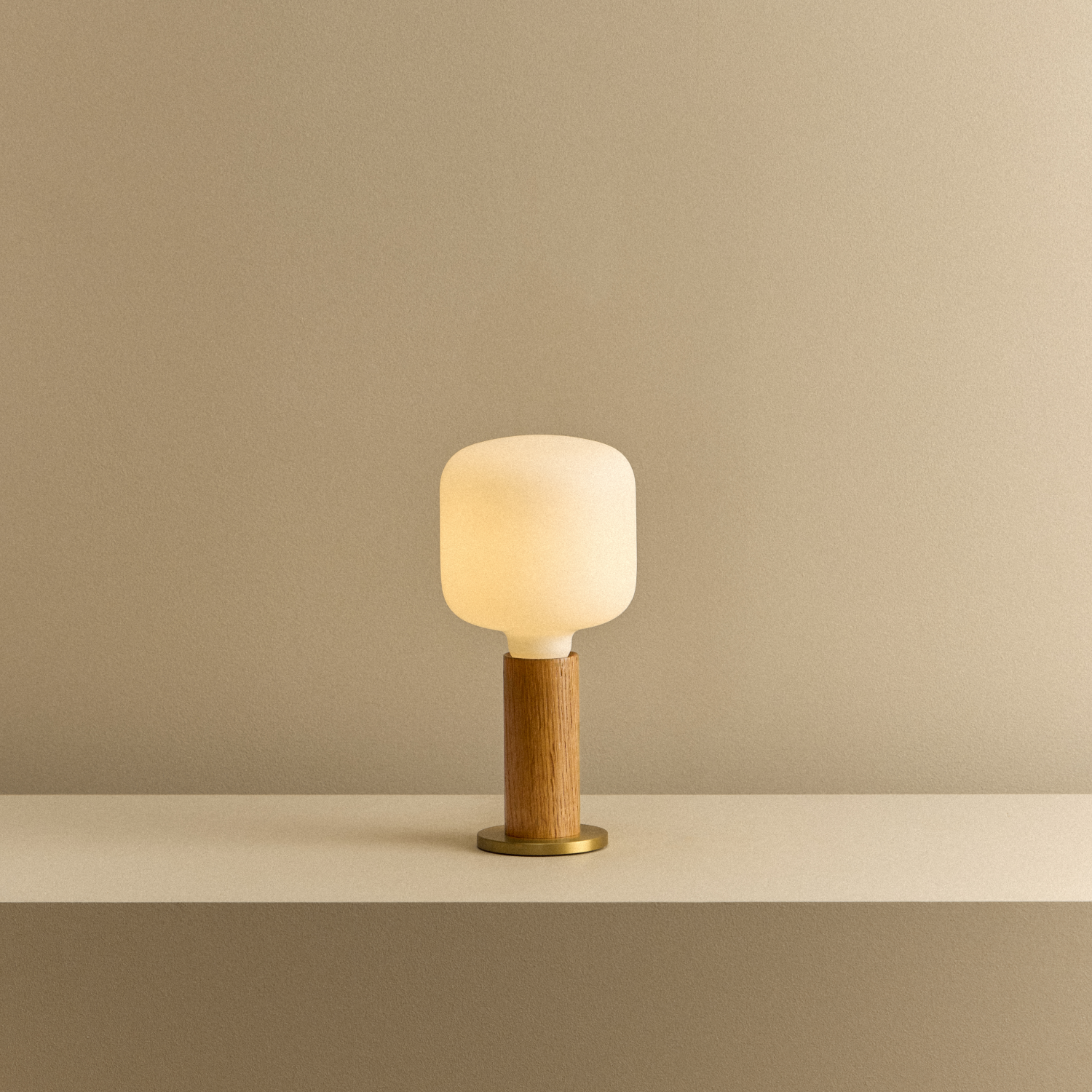 Knuckle Table Lamp in Oak with Oblo bulb, illuminated