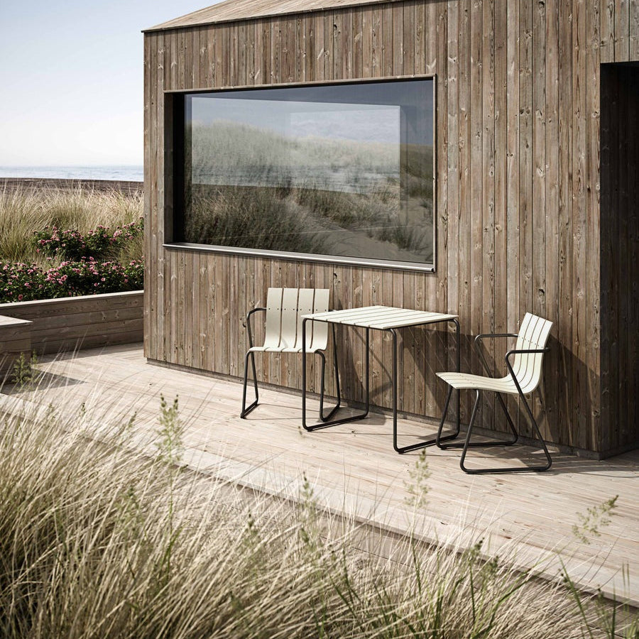 Mater Ocean Chair styled in an outdoor setting, slats of recycled plastic waste