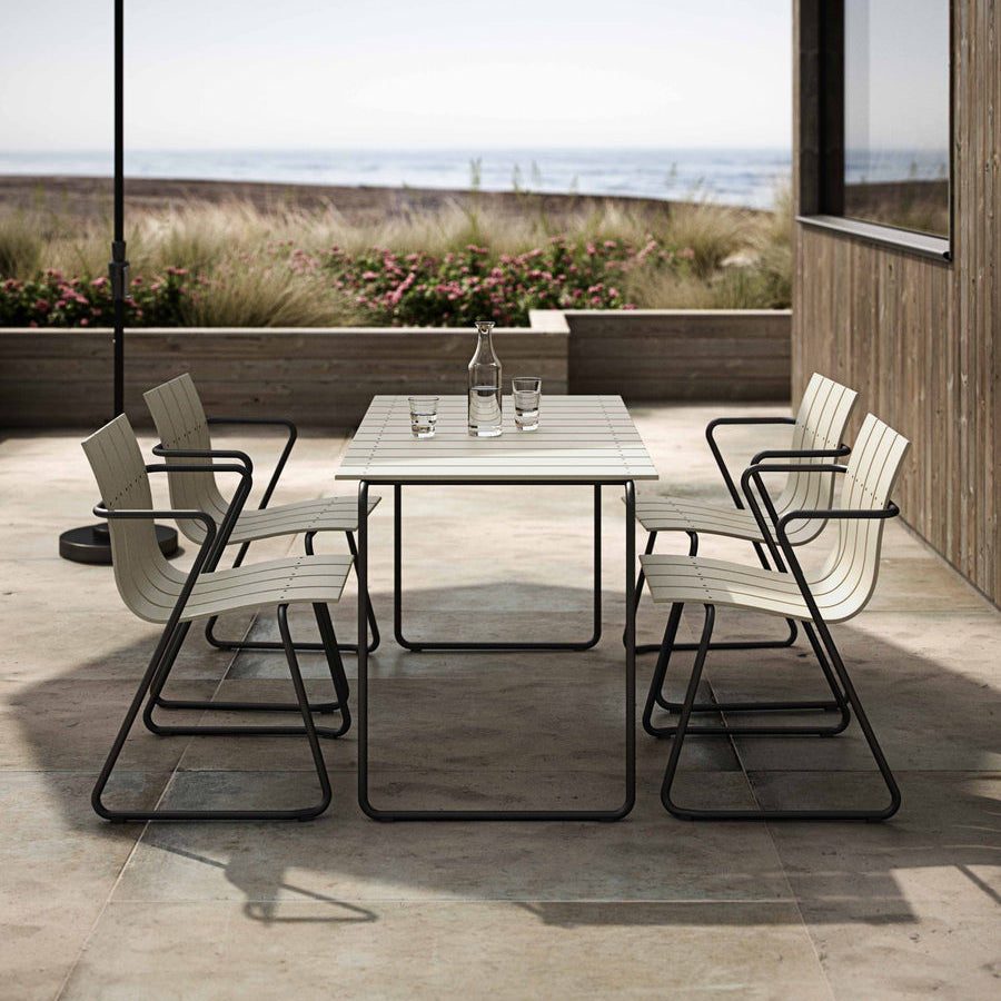 Mater Ocean Chair styled in an outdoor setting, slats of recycled plastic waste