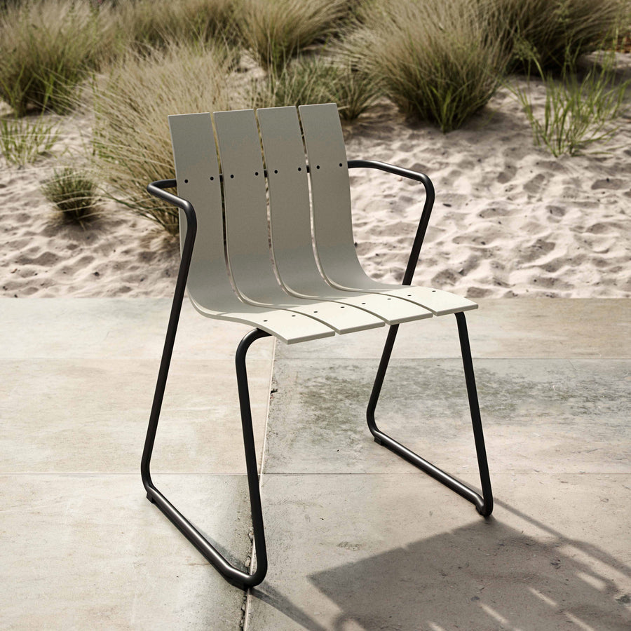 Mater Ocean Chair styled in an outdoor setting, slats of recycled plastic waste