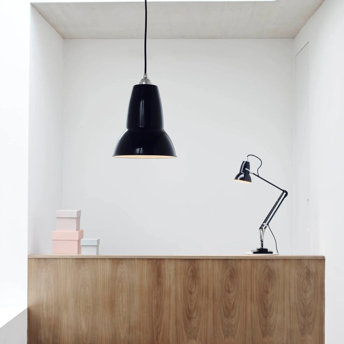 Anglepoise Original 1227 pendant in Jet Black above a wooden counter