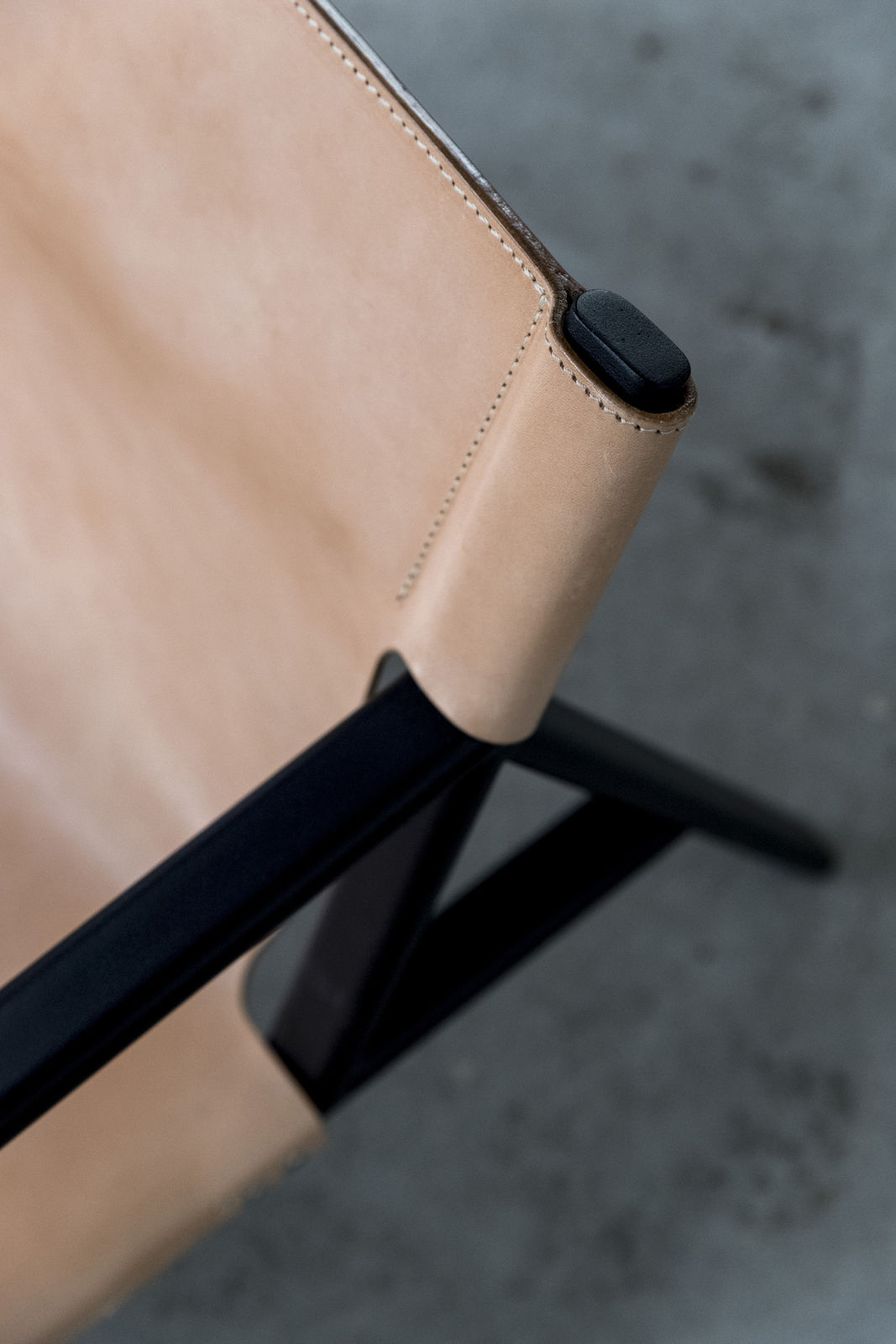 Detail of Bent Hansen Tension Lounge Chair showing the saddle leather fixed to the steel frame
