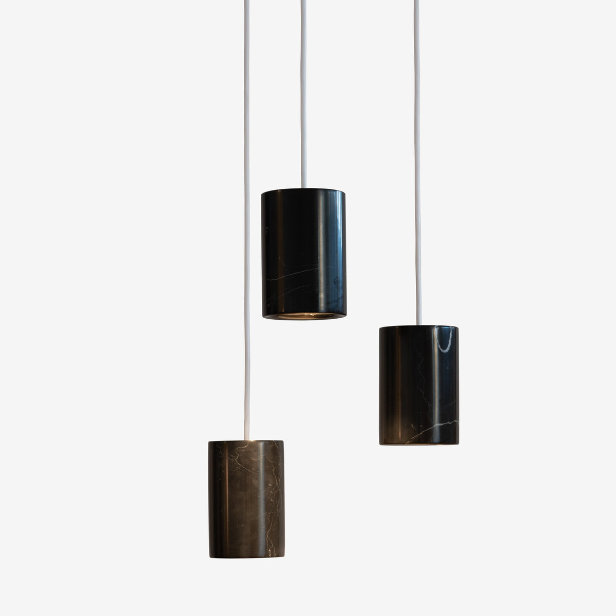 Case Solid Three Pendant Cluster in Nero Marquina, staggered cylinders, Nero Marquina marble