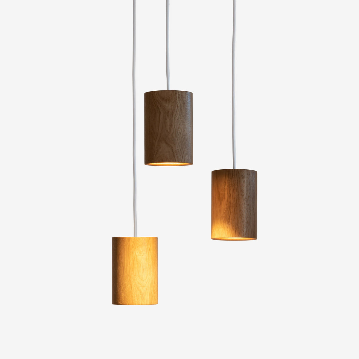 Case Solid Three Pendant Cluster in Oak, staggered cylinders, solid oak