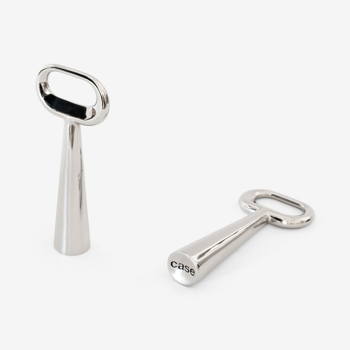 Detail of Case Stand Bottle Opener showing the cast Case logo on the base, polished stainless steel