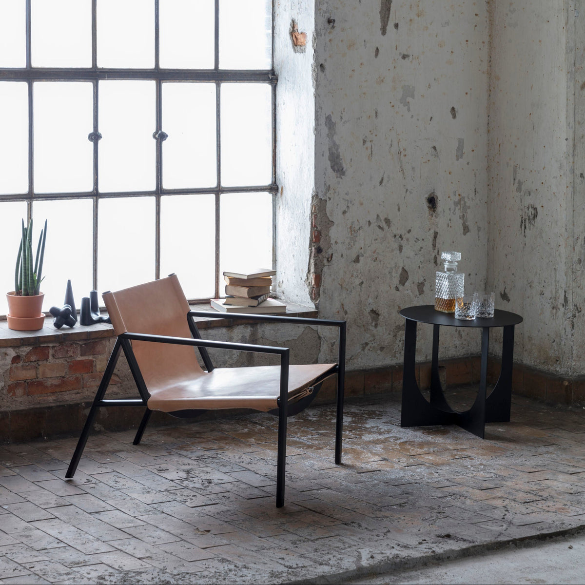 Bent Hansen Tension Lounge Chair in natural saddle leather, styled in an interior setting, steel and leather