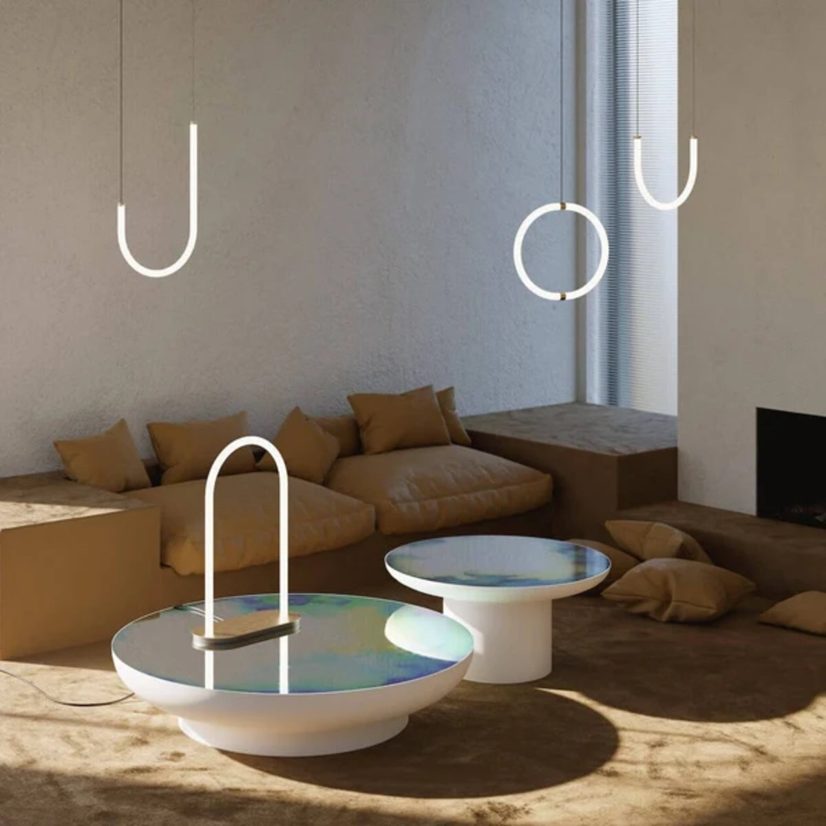 Petite Friture Unseen J pendant lights in brass and white glass above low tables