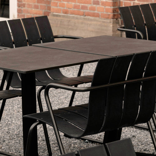 Mater Ocean Chair styled in an outdoor setting, slats of recycled plastic waste