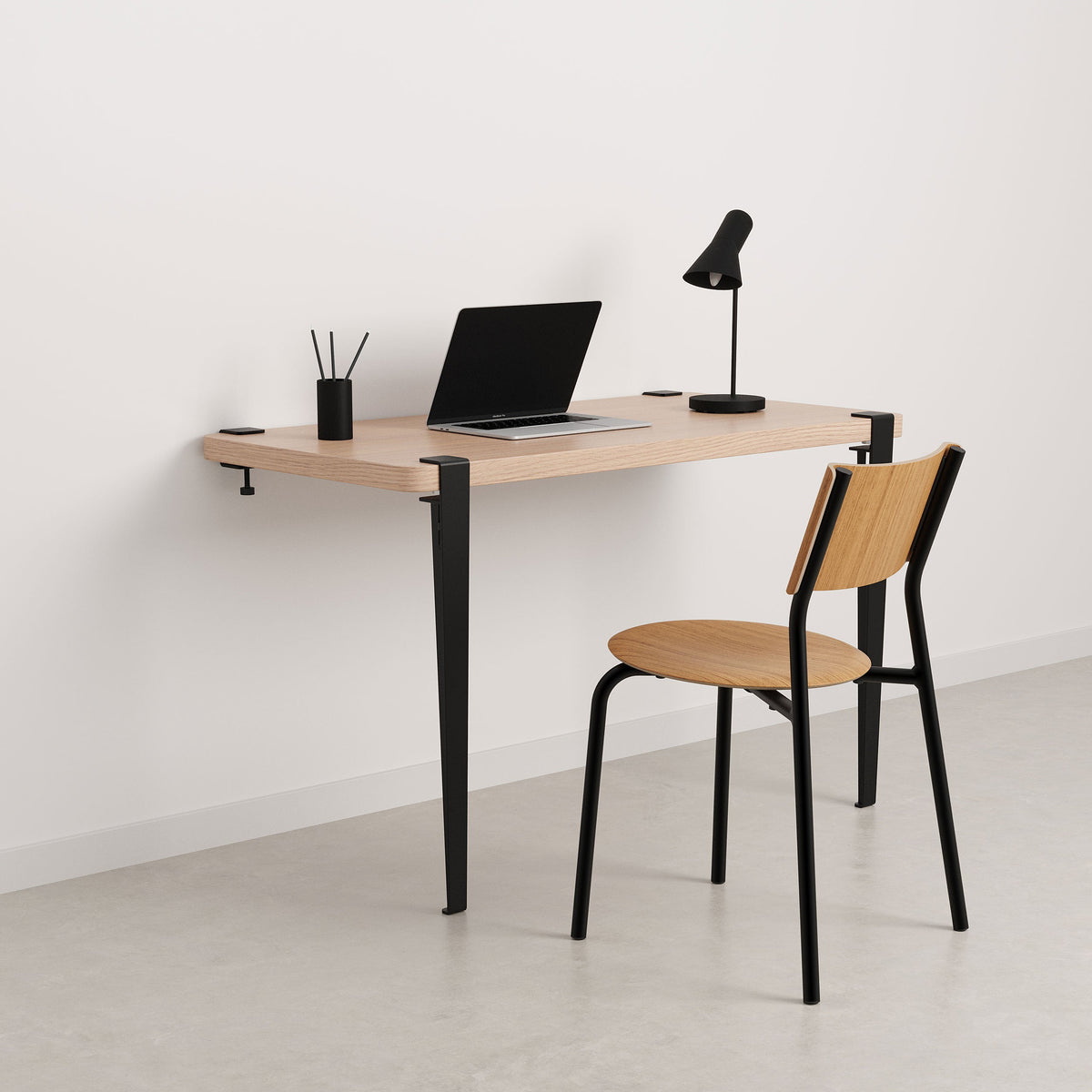 Tiptoe Wall Desk in Graphite Black, styled as a home office with a chair, oak veneer and powder-coated steel