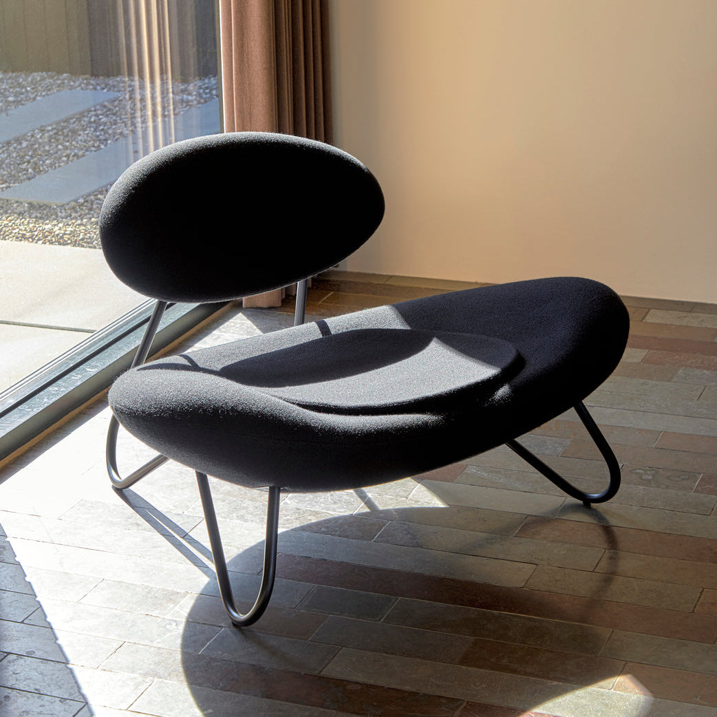 WOUD Meadow Lounge Chair in upholstered fabric on a solid oak frame styled in a living room