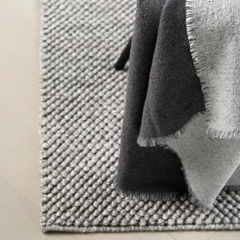 WOUD Tact Rug in hand-tufted wool styled in a living room