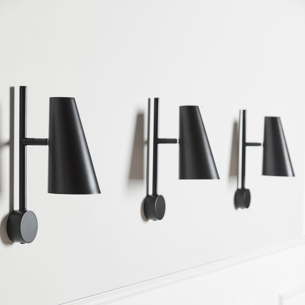 WOUD Cono Wall Lamp in powder-coated steel styled in a living room