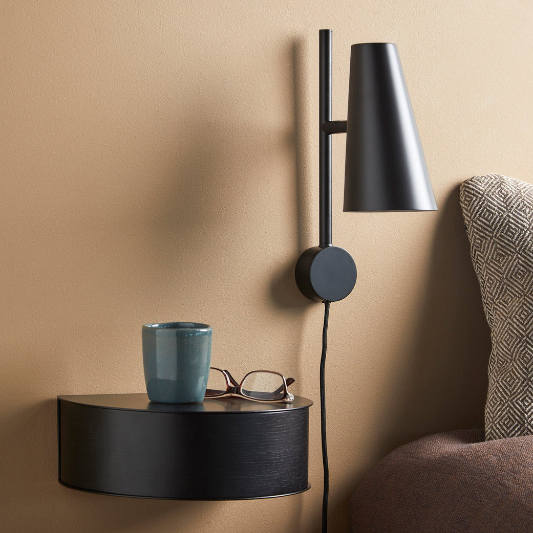 WOUD Cono Wall Lamp in powder-coated steel styled in a living room