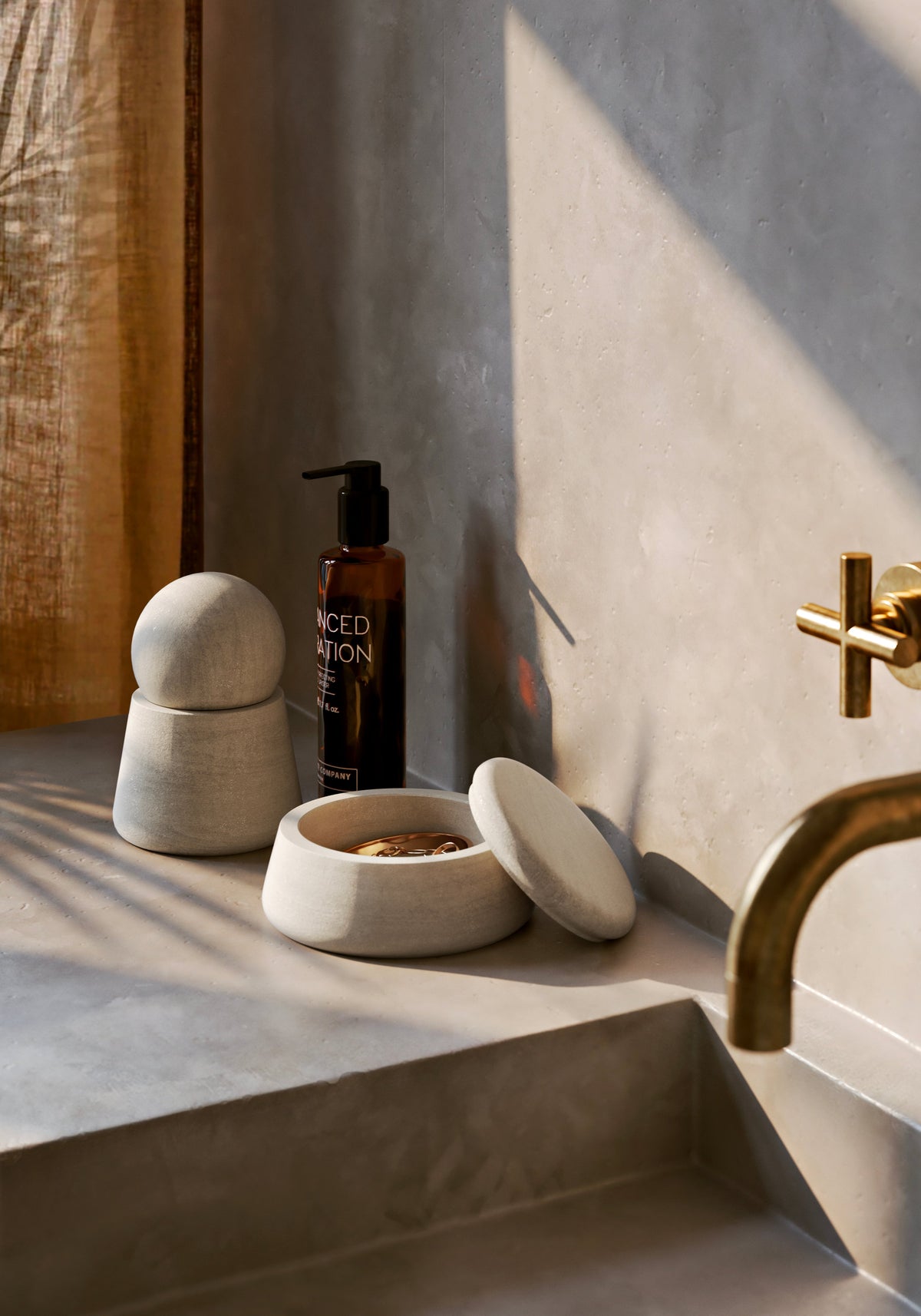 WOUD Serene Jars, Low and Tall, in Grey Sandstone, styled beside a bathroom basin, solid natural stone