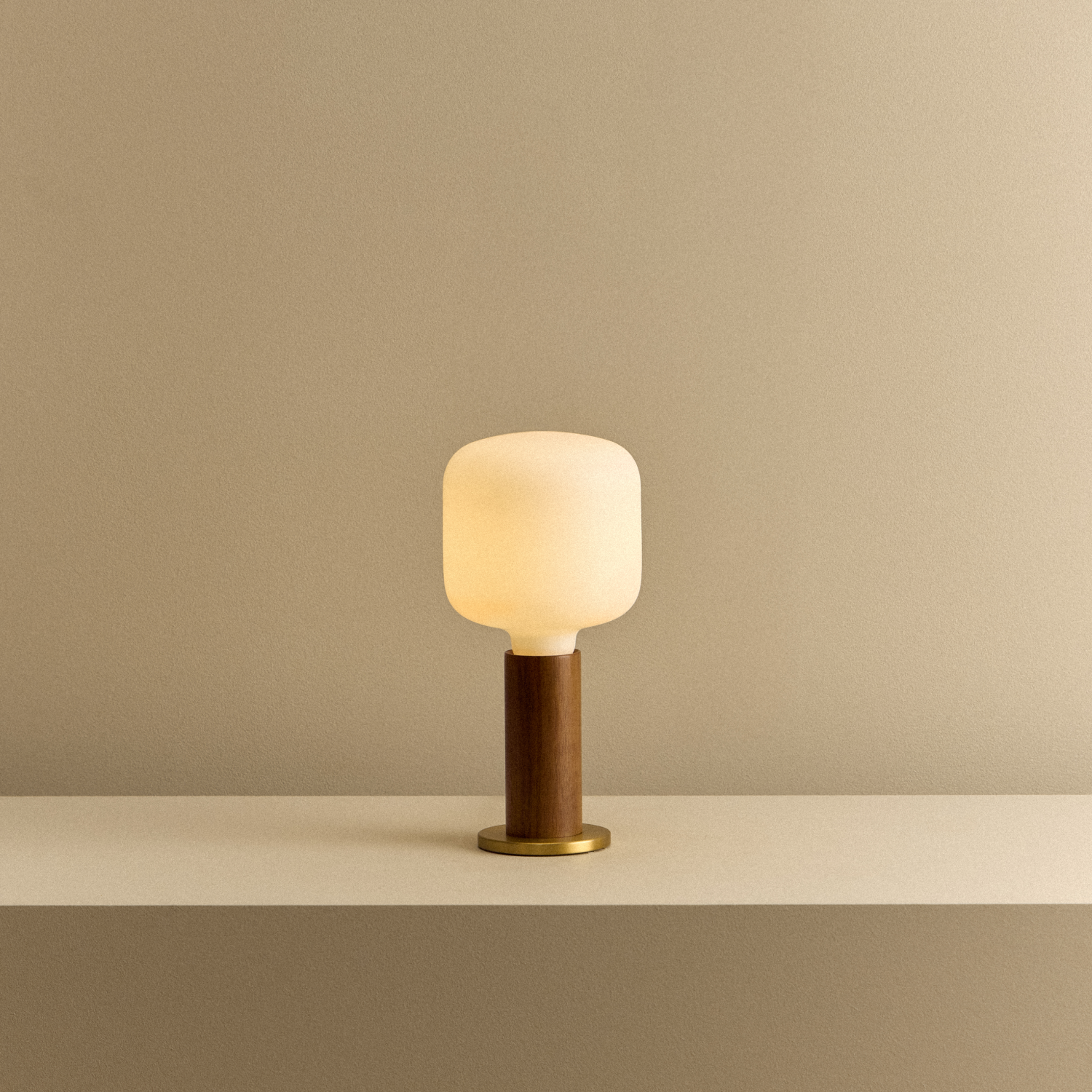 Knuckle Table Lamp in Walnut with Oblo bulb, illuminated