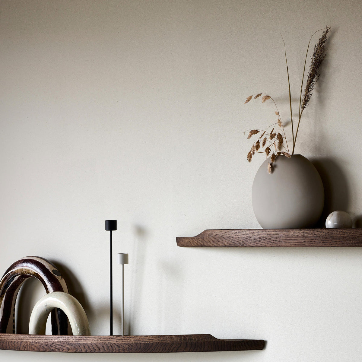 Aakjaer Arcus shelves in smoked oak styled with ceramic arches and a vase
