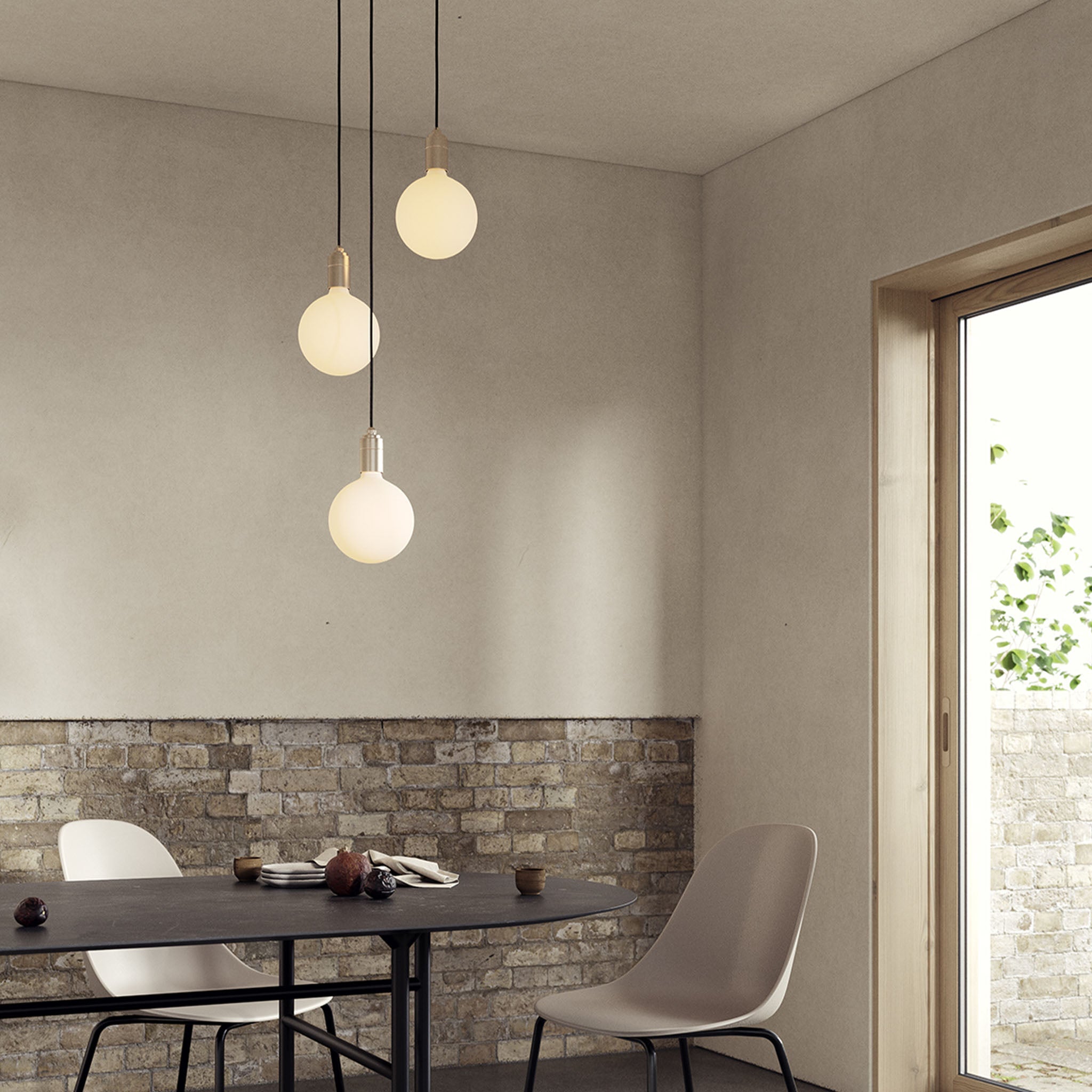 Tala Triple Pendant in Brass with Sphere IV bulbs — dining room lifestyle