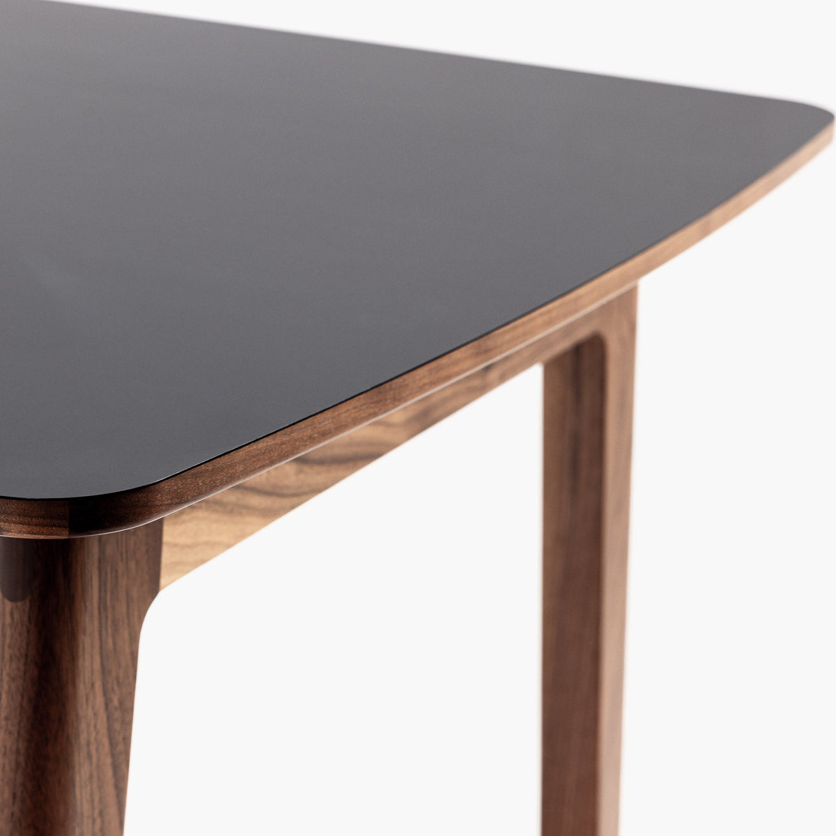 Detail of Case Dulwich Bar Table showing the black HPL laminate top on a walnut frame