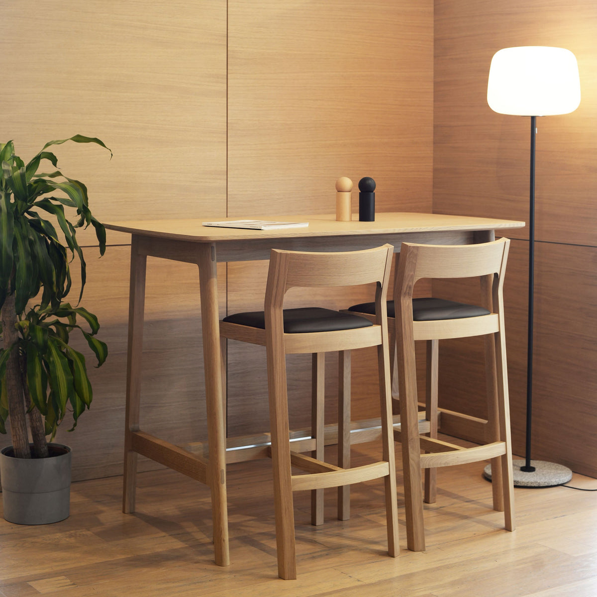 Case Dulwich Bar Table in Oak with two bar stools, styled in an interior setting, solid oak