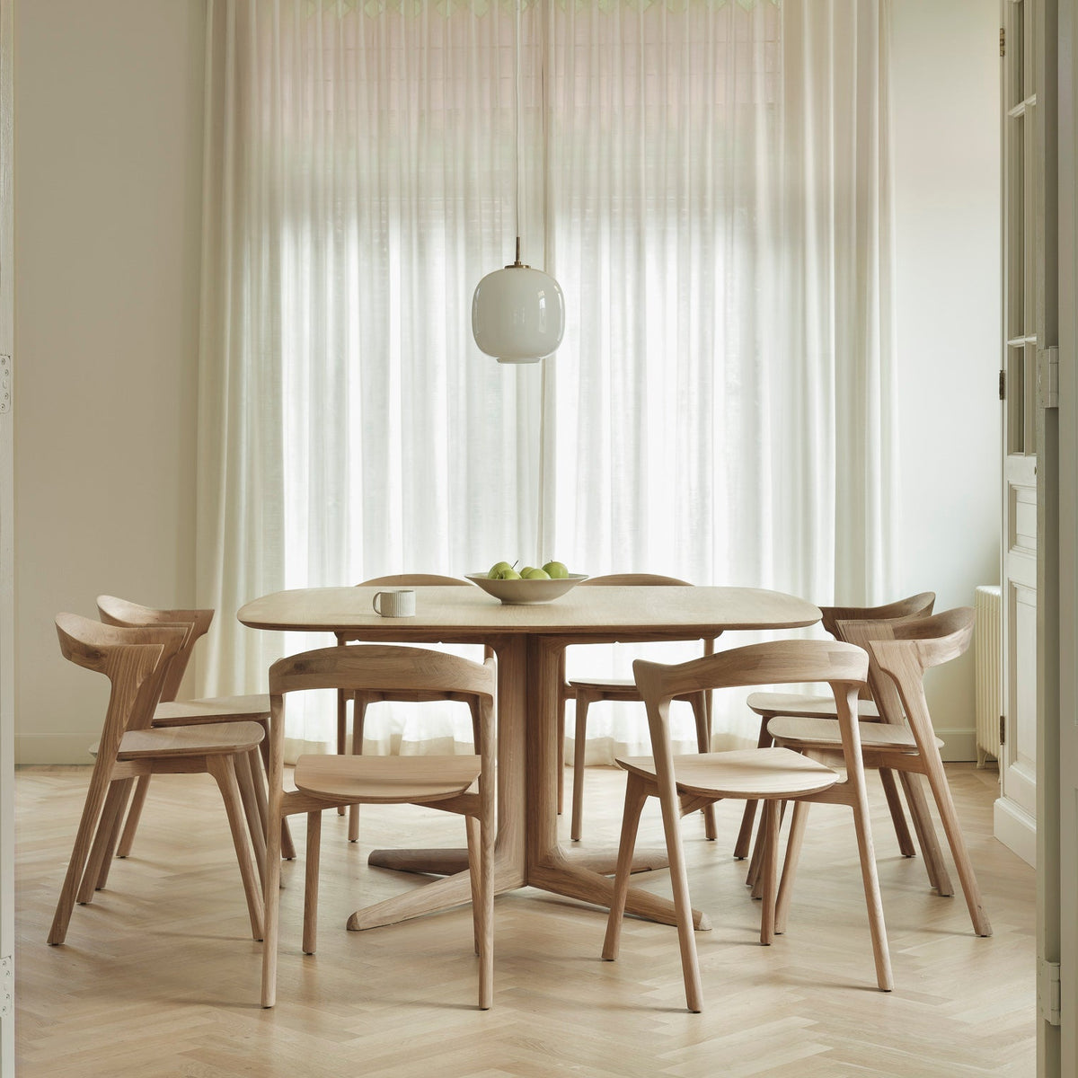 Ethnicraft Corto Dining Table in oak with oak dining chairs, styled in a dining room, solid oak