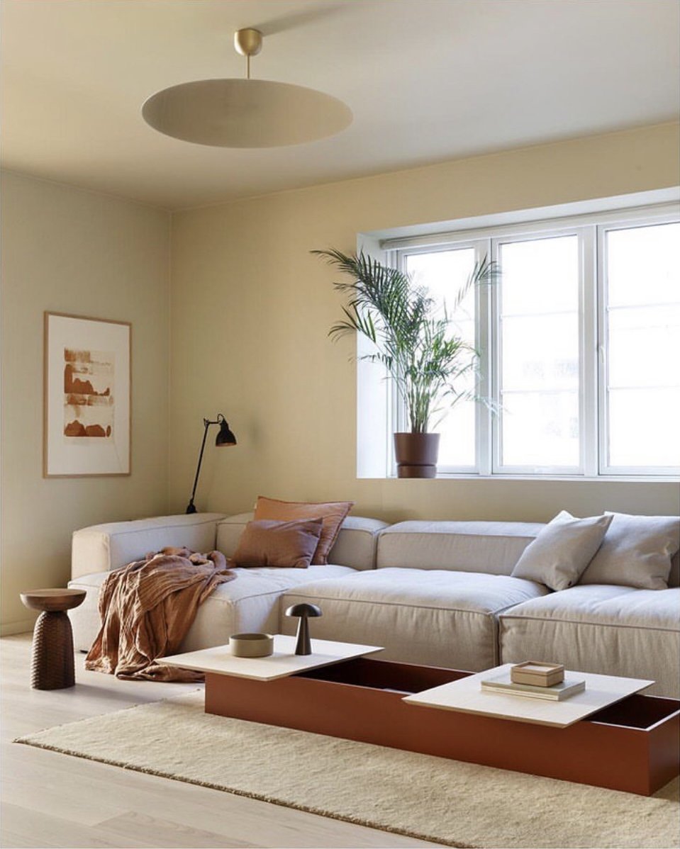 Luceplan Millimetro Pendant with a mirror disc above a living room sofa