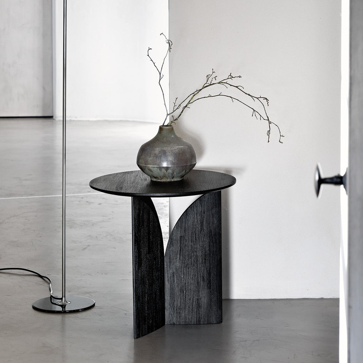 Ethnicraft Fin Side Table in Teak Black, styled in an interior setting, black-tinted FSC-certified solid teak
