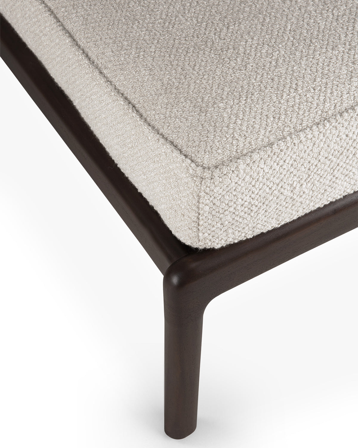 Detail of Ethnicraft Jack Footstool showing the Ivory bouclé cushion on the mahogany frame