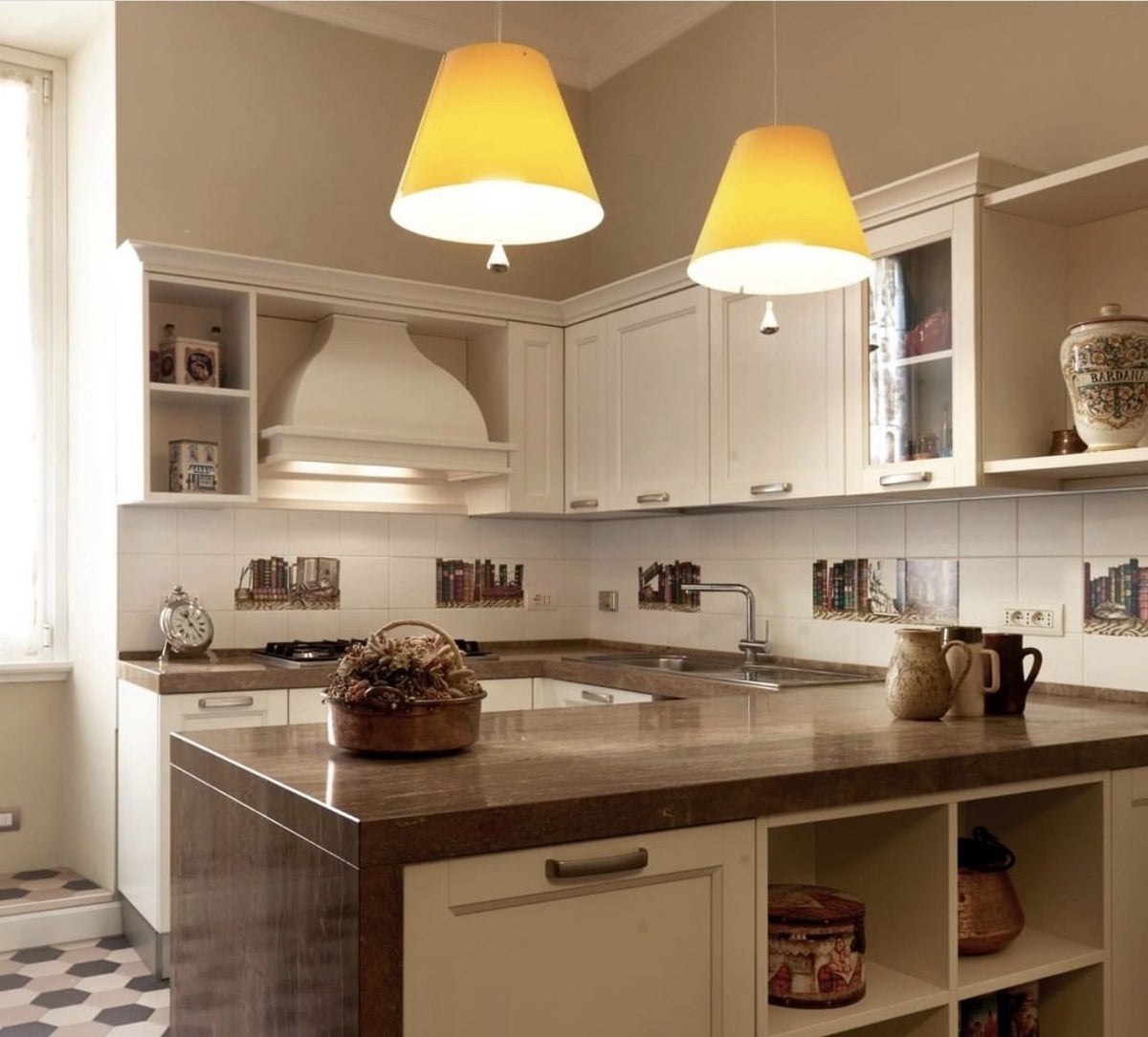 Luceplan Costanza Pendants with yellow shades over a kitchen island, styled in an interior setting