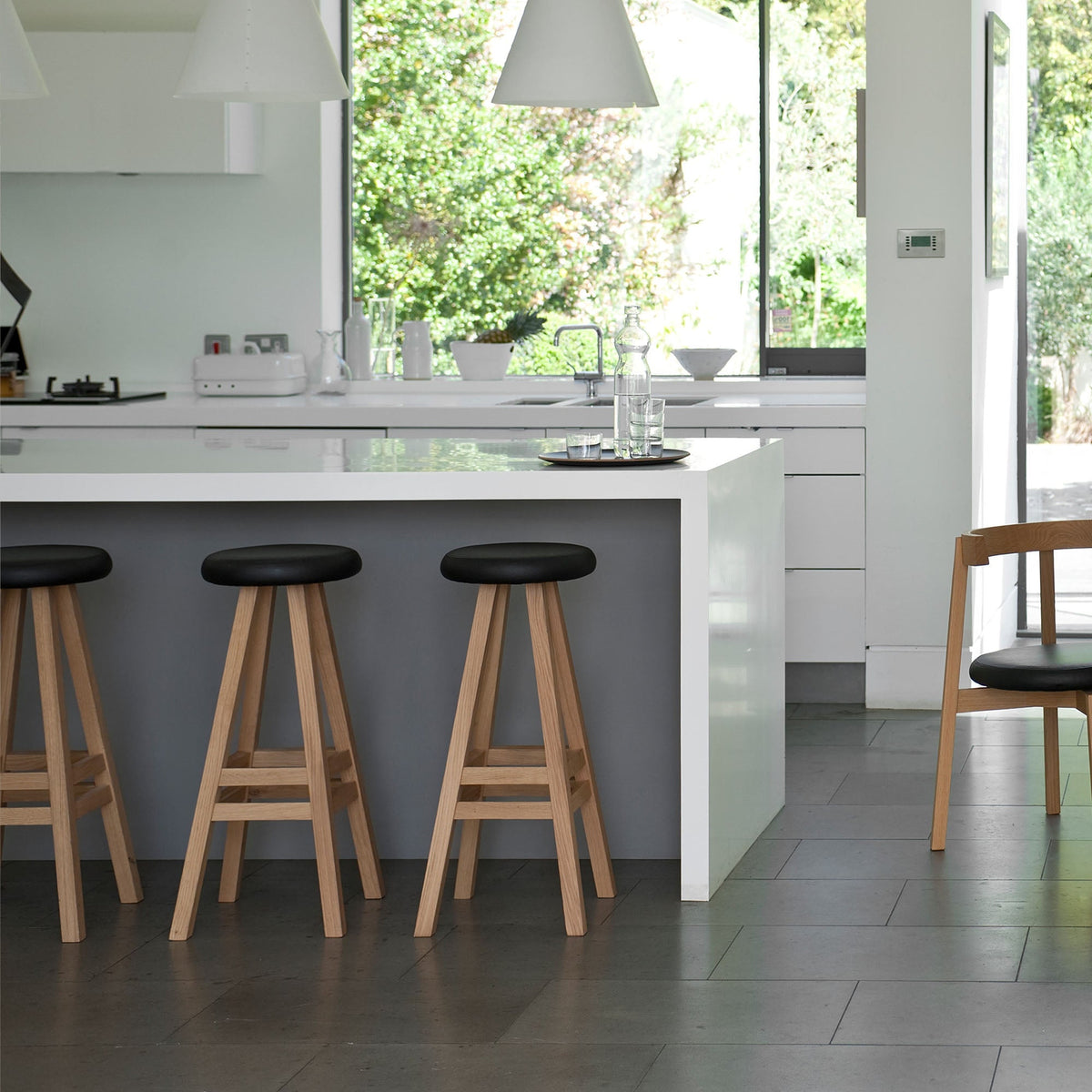 Case Oki-Nami Stools in Oak at a kitchen island, styled in an interior setting, solid oak
