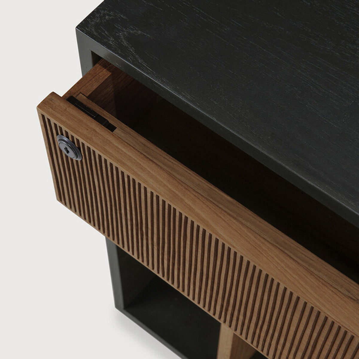 Detail of Ethnicraft Oscar Drawer Unit showing the open drawer and its hand-carved teak front