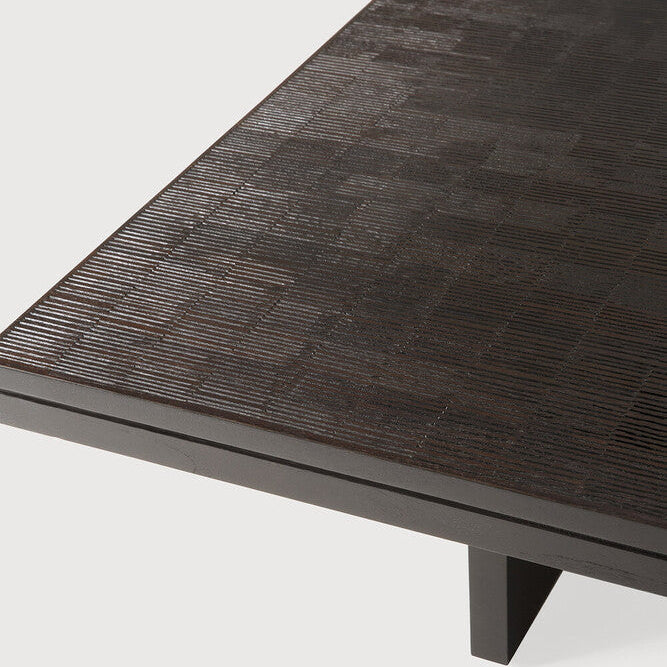 Dark wooden coffee table with a textured surface on a white background