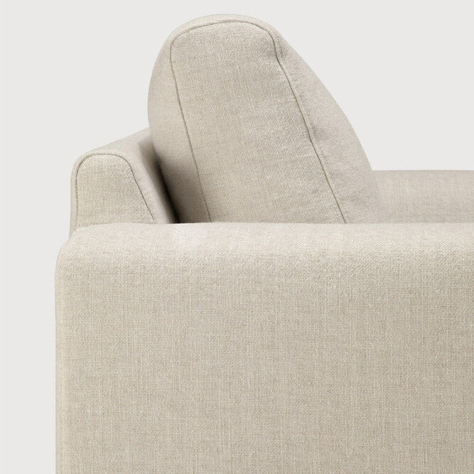 Detail of Ethnicraft Ease Sofa showing the broad upholstered armrest